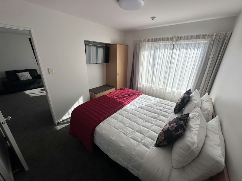 One-Bedroom Deluxe Apartment separate bedroom with king bed