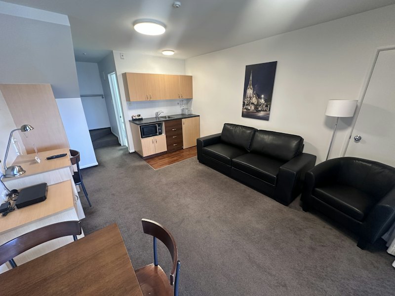 Split Level Apartment lounge with leather sofas and kitchenette