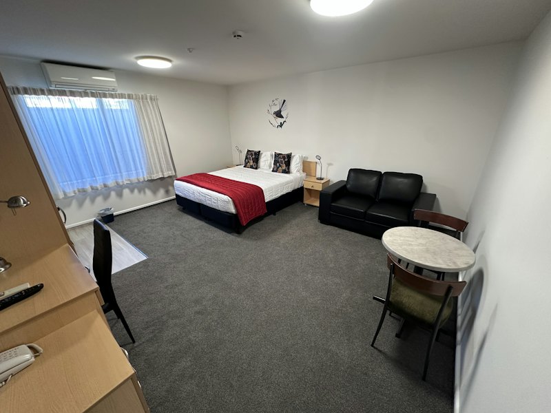 Standard Studio with king bed, sofa and dining table