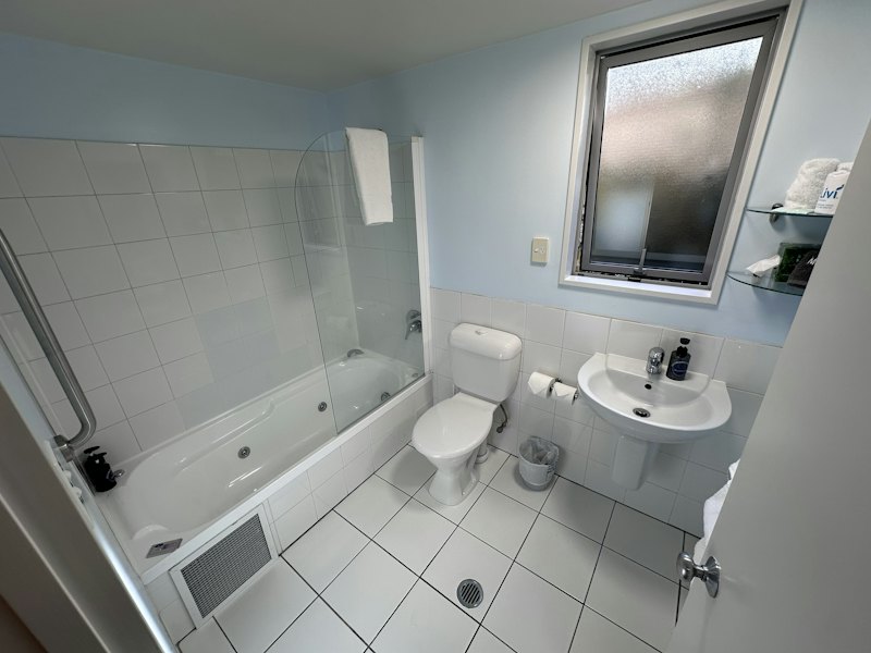 Superior Studio bathroom with bath and shower